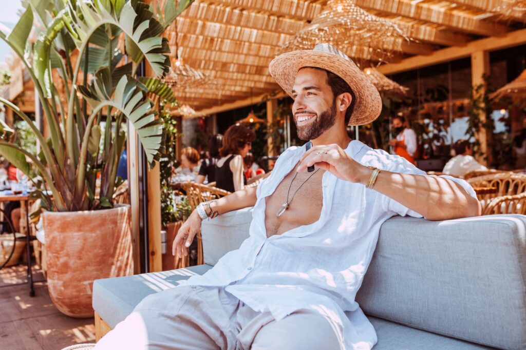 Handsome smiling man at terrace restaurant